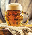 Beer. Two cold beers. Draft beer. Draft ale. Golden beer. Golden ale. Two gold beer with froth on top. Draft cold beer in glass jars in home pub hotel or restaurant. Still life.