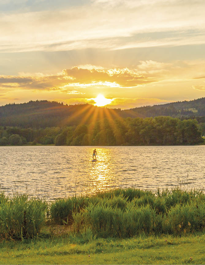 stand up paddeling on lake lipno in Bohemia at sunset