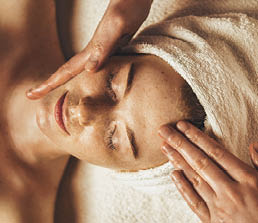 Close-up of young woman getting spa massage treatment at beauty spa salon. Cosmetology beauty skin care anti-aging treatment rejuvenation. Body care, spa. Facial beauty. Woman beauty face. Healthy lifestyle.